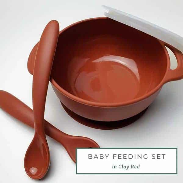 A set of colorful bowls with spoons and forks.