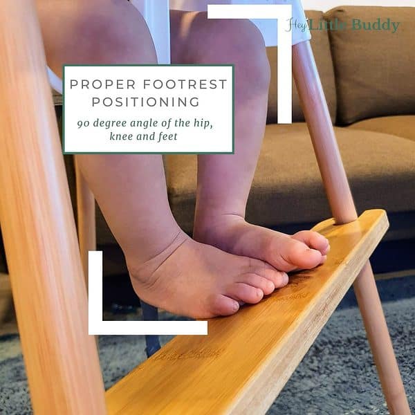 A child's feet on a 2021 wooden high chair with Footrest for Ikea Antilop Baby Highchair - Bamboo, Maple, & Bamboo in Black footrest.