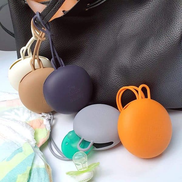 A bag with several different colored pacifiers on it.