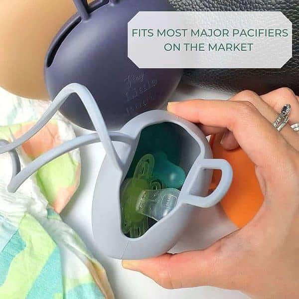 A person holding a baby's pacifier with the text fits most major pouches on the market.