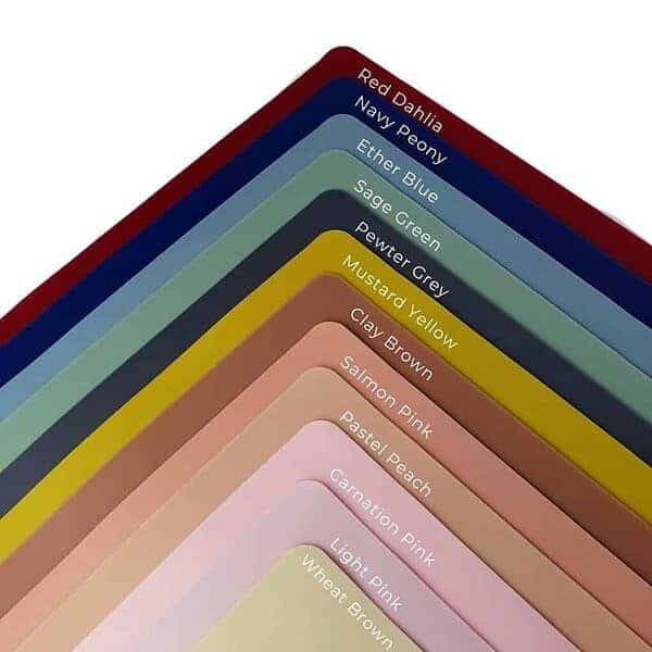 A stack of different colored paint swatches on a white background.