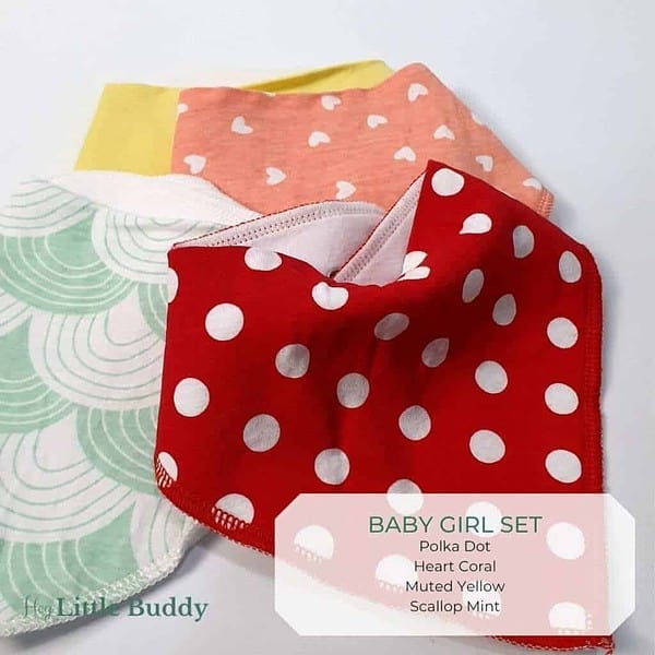 A set of baby girl bibs with polka dots on them.