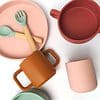 A set of plates, bowls, spoons and utensils.