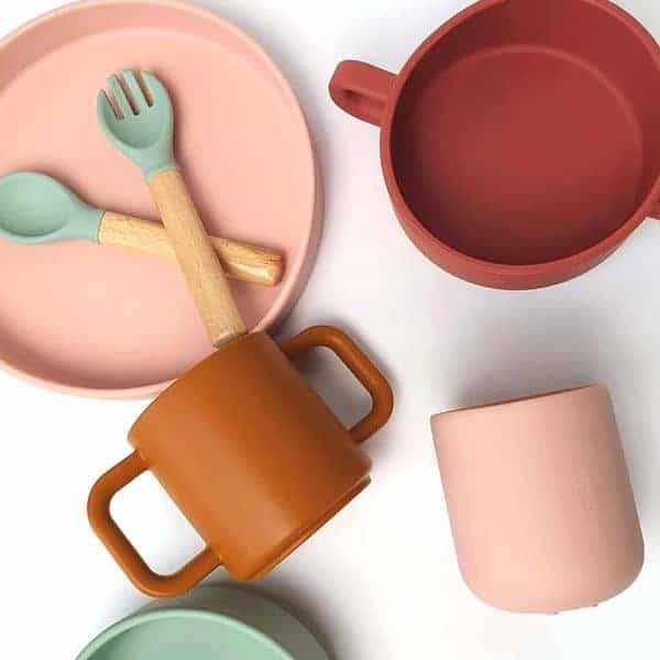 A set of plates, bowls, spoons and utensils.